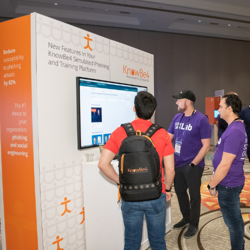 Visitors to the KnowBe4 booth waching a video